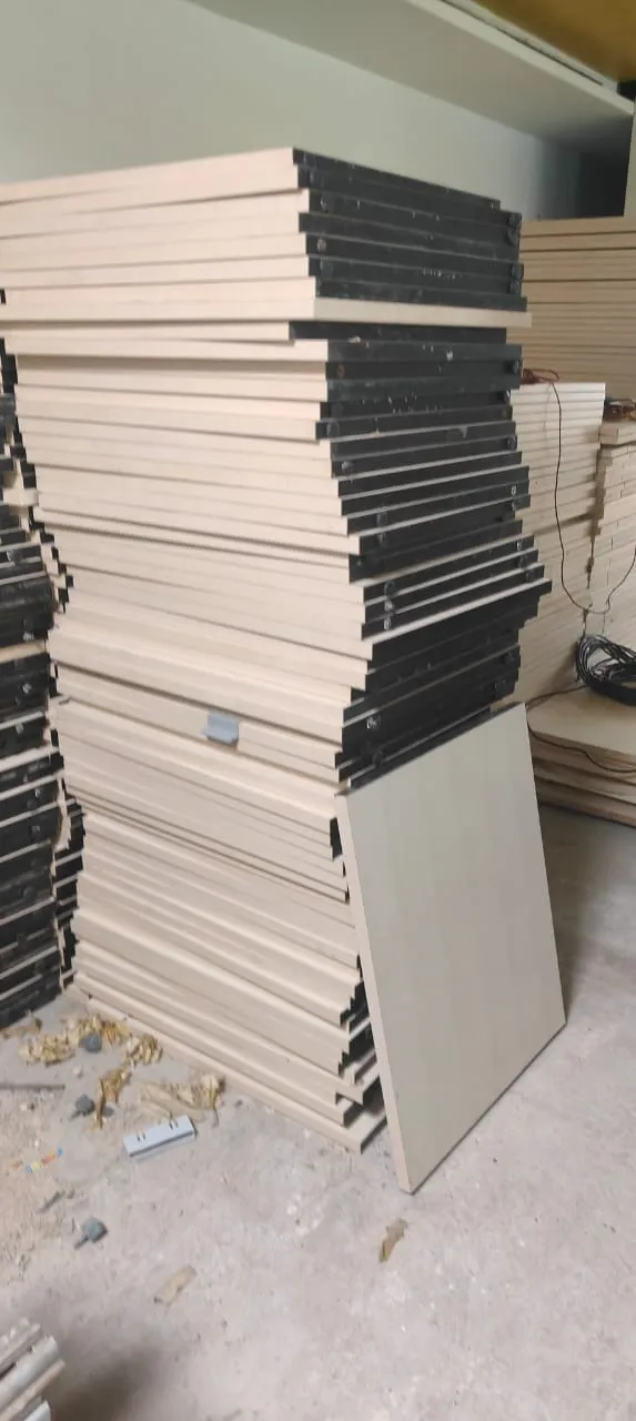 Wooden worktops and modular cubicle partitions flat-packed during a professional office furniture dismantling Bellandur project.