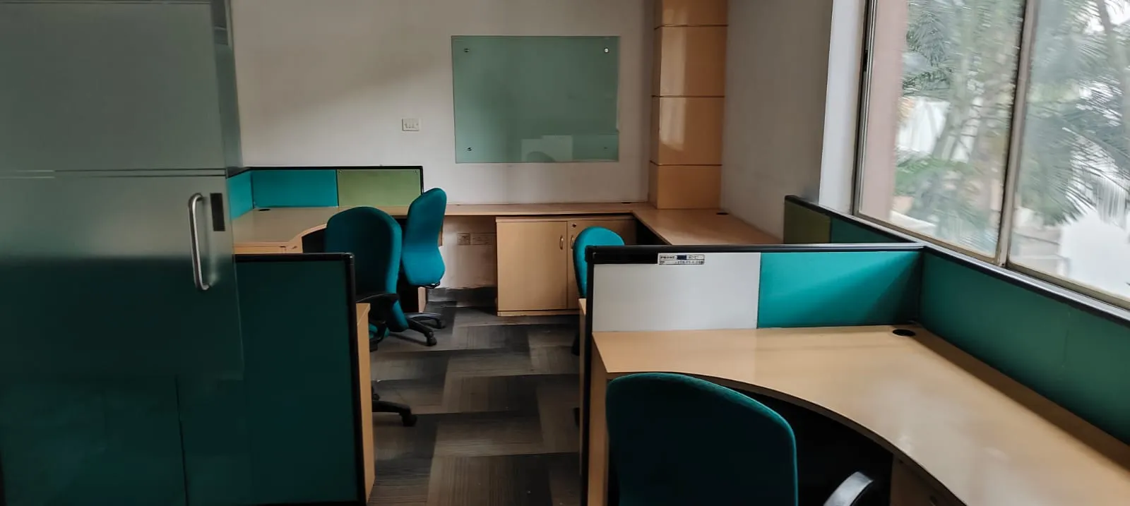 Empty modern open-plan linear desk systems configured inside an IT hub before workstation removal Bellandur.